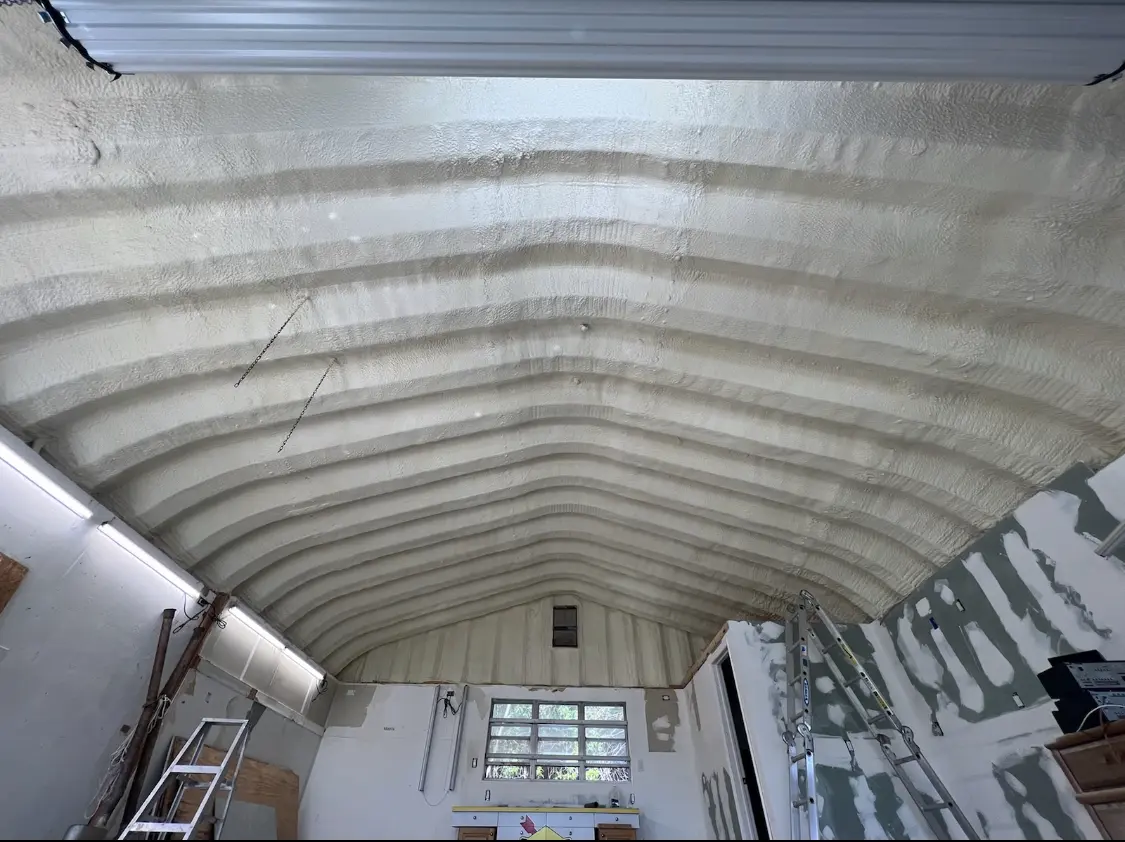 Spray polyurethane foam applied to the underside of a metal roof deck in Linthicum